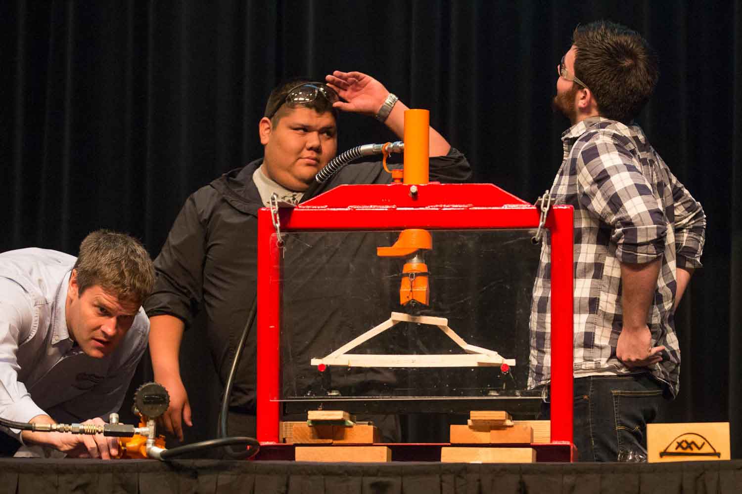 Engineering students working with a machine.