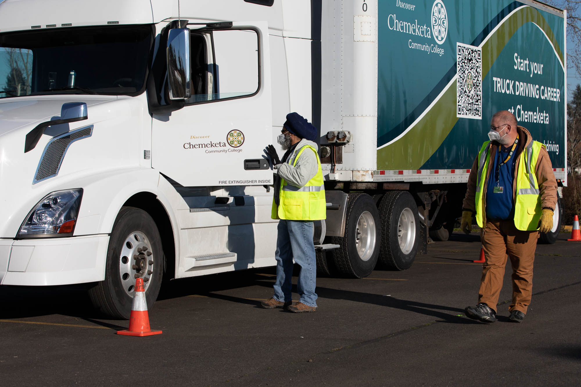Truck driving instructor and student with truck